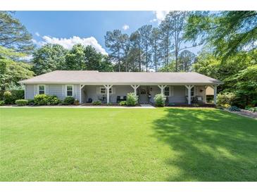 Charming single story home with a large yard and covered porch at 515 Houze Way, Roswell, GA 30076