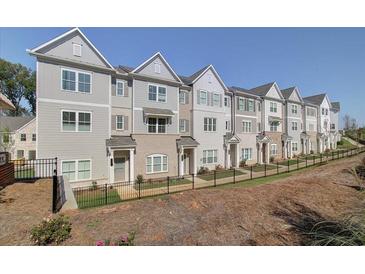 Row of attractive townhomes featuring neutral colors, and modern architectural details at 1923 Deco Dr, Kennesaw, GA 30144