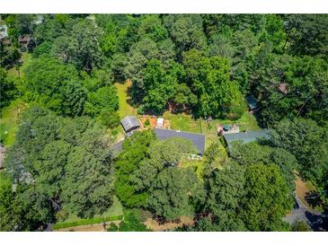 Secluded property featuring a long, private driveway and a lush wooded landscape, perfect for peaceful living at 3425 Poplar Dr, Lawrenceville, GA 30044