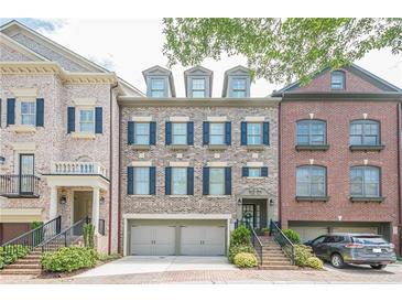 Charming brick townhome featuring a two-car garage and classic black shutters at 2295 Falmouth Se Ct, Smyrna, GA 30080