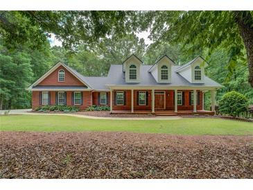 Charming brick home with a welcoming front porch and well-manicured lawn at 15 Walnut Ridge Way, Covington, GA 30014