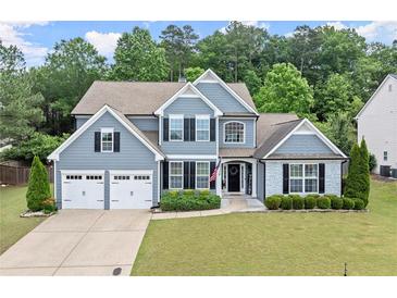 Charming two-story home with a well-manicured lawn and attached two-car garage at 214 Crestmont Way, Canton, GA 30114