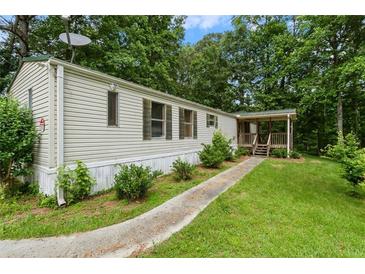 Charming manufactured home with a well-maintained lawn and inviting front porch at 4934 Pickys Se Holw, Acworth, GA 30102