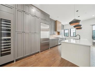 Spacious kitchen featuring a large island, stainless steel appliances, and a wine refrigerator at 71 Krog Ne St, Atlanta, GA 30307