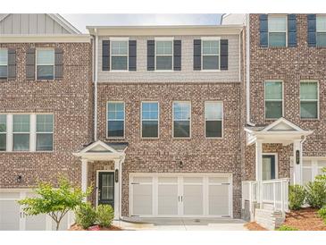 Stylish brick townhome with a two-car garage and well-maintained landscaping at 123 Matson Sw Run, Mableton, GA 30126
