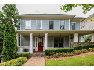 Charming two-story home featuring a welcoming front porch, red door, and beautifully landscaped front yard at 775 A Harrison Se Pl, Atlanta, GA 30315