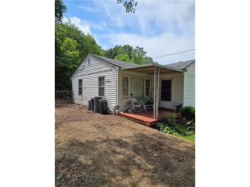 An exterior view of a one-story home with white siding and a covered porch at 4253 Hanes Dr, Decatur, GA 30035