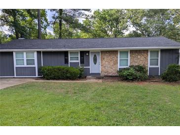 Charming single story home with a stone facade and a well-manicured front lawn, exuding curb appeal at 4448 Denise Dr, Decatur, GA 30035