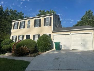 Charming two-story home with a two-car garage, manicured bushes and black shutters at 2584 Shadowbrook Dr, Decatur, GA 30034