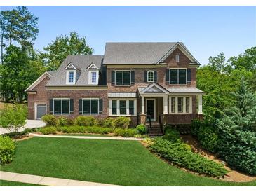 Beautiful brick home with manicured lawn and mature trees, offering classic elegance and curb appeal at 1393 Kings Park Nw Dr, Kennesaw, GA 30152