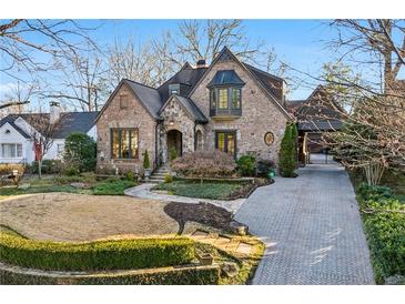 Charming brick home with manicured lawn, stone accents, and inviting curb appeal at 1031 Eulalia Ne Rd, Atlanta, GA 30319