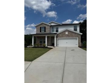 Charming two-story home with neutral brick, attached two car garage, and well-maintained lawn at 4477 Bethany Manor Dr, Snellville, GA 30039