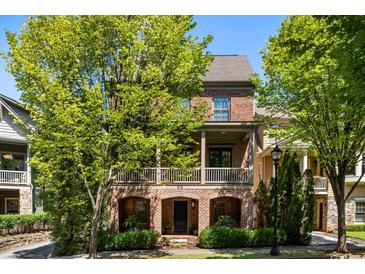 Charming two-story brick home with a covered front porch and mature trees offering shade at 970 N Ormewood Park Se Dr, Atlanta, GA 30316