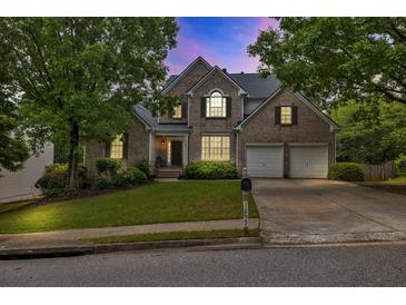 Charming two-story brick home with a well-manicured lawn and a two-car garage at 1255 Hidden Creek Pt, Cumming, GA 30040
