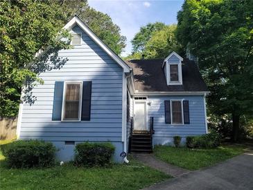 Charming home featuring light-blue siding, a well-manicured lawn, and classic architectural details at 4 Kelso At Peyton Sw Dr, Atlanta, GA 30311