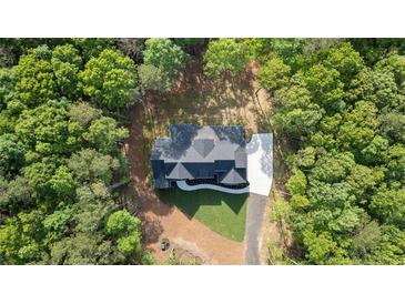 A beautiful new construction home is nestled in a private, wooded lot with long driveway and fresh sod at 5567 Tyree Rd, Winston, GA 30187