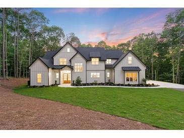 Stunning modern farmhouse with a manicured lawn and professional landscaping at 5567 Tyree Rd, Winston, GA 30187