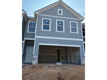 New construction home featuring a two-car garage and classic exterior details at 218 Seward St # 92, Conyers, GA 30094
