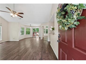 Inviting living room with hardwood floors, ceiling fan, and sliding glass doors to outdoor space at 909 Wentworth Ct, Alpharetta, GA 30022