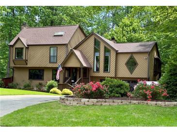 Inviting two-story home featuring a unique design, colorful landscaping, and charming front entrance at 2694 Tritt Springs Ne Dr, Marietta, GA 30062