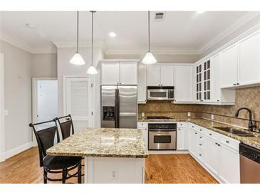 Beautiful kitchen with granite countertops, stainless steel appliances, and white cabinetry at 11 Perimeter E Ctr # 1402, Dunwoody, GA 30346
