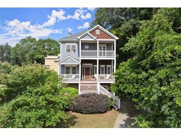 Charming two-story home with double porches, lush landscaping, and inviting curb appeal at 1797 Olive Se St, Atlanta, GA 30315