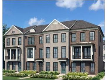 A lovely new townhome with elegant brick, a large porch, and manicured landscaping at 205 Midnight Oak Run # 5, Alpharetta, GA 30009