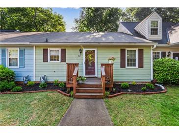 Charming home with a well-maintained lawn, flower beds, and inviting front porch entrance at 812 Manning Sw Way, Marietta, GA 30064