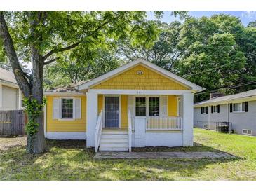 Charming bungalow featuring a cozy front porch and a cheerful yellow and white exterior at 103 Chicamauga Sw Ave, Atlanta, GA 30314