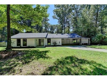 Charming single-story home with a well-manicured lawn and convenient carport at 1192 Sandalwood Dr, Lawrenceville, GA 30043
