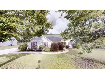 Charming single-story home with well-manicured lawn and mature trees at 150 Mills Creek Ln, Covington, GA 30016