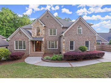 Charming two-story brick home with manicured landscaping and a welcoming entrance at 980 Pine Grove Rd, Roswell, GA 30075