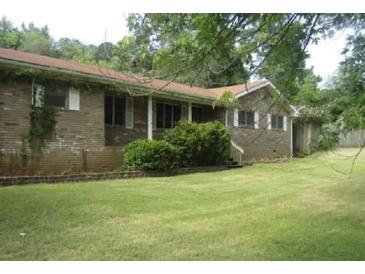 Traditional brick ranch with a well-maintained lawn at 6290 S Skyline Dr, Douglasville, GA 30135