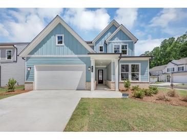 Charming two-story home with light blue siding, white trim, and a well-manicured lawn at 212 Birchwood Row, Canton, GA 30115