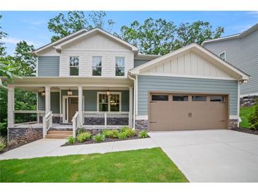 Charming home with a welcoming front porch, a well-manicured lawn, and a two-car garage at 2714 Eagles Crest Ln, Decatur, GA 30034