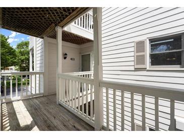 Condo exterior featuring a wooden balcony with white railing and white siding with shutters at 403 Abingdon Way, Atlanta, GA 30328