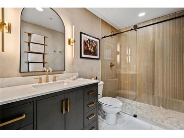 Modern bathroom features an elegant vanity with stone countertop and a glass-enclosed shower at 860 Peachtree Ne St # 1513, Atlanta, GA 30308