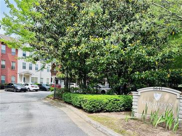 View of the Brighton Court community entrance and surrounding landscaping at 5641 Roswell Rd # 111, Sandy Springs, GA 30342