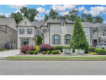 Beautiful two-story home featuring a brick exterior, manicured lawn, and tasteful landscaping at 1839 Kent Ave, Atlanta, GA 30338