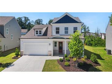 Beautiful two-story home with a manicured lawn, attached garage and lovely front porch at 803 Levi Farm Ln, Canton, GA 30115