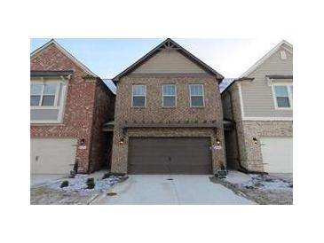 Beautiful two-story brick home with a two-car garage and a well-maintained yard at 8265 Village Pl, Suwanee, GA 30024