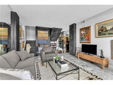Bright living room with marble floors, modern decor, and plentiful artwork on display at 145 15Th Ne St # 409, Atlanta, GA 30309