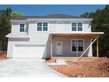 Two-story home with gray siding, white trim, an attached garage, and a covered front porch at 2462 Adair Ridge Ct, Decatur, GA 30034
