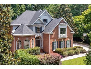 Beautiful two-story brick home with lush landscaping and a well-manicured front yard at 4567 Brigade Ne Ct, Roswell, GA 30075