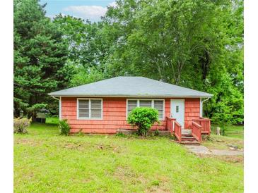 Cozy one-story home with charming front porch and mature trees at 551 Barnes Mill Dr, Marietta, GA 30062