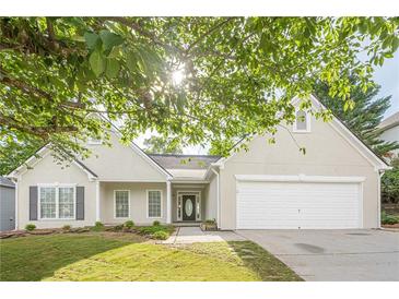 Charming one-story home featuring a well-manicured lawn, a two-car garage, and a welcoming front entrance at 861 Soaring Dr, Marietta, GA 30062
