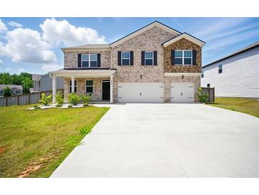 Charming two-story brick home featuring a spacious driveway and attached two-car garage at 2804 Torunn Ct, Atlanta, GA 30331
