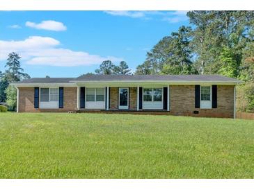 Charming single-story brick home with a well-manicured lawn and traditional window shutters at 4129 Pepperdine Dr, Decatur, GA 30034