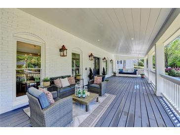 Relaxing covered porch showcasing stylish outdoor furniture and a charming porch swing for ultimate comfort at 5567 Stapleton Dr, Dunwoody, GA 30338