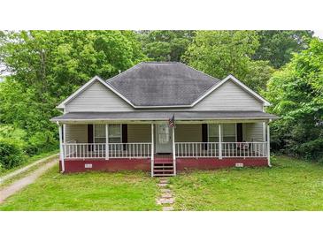 Charming single-story home with a welcoming front porch and lush green lawn at 232 S Candler St, Villa Rica, GA 30180